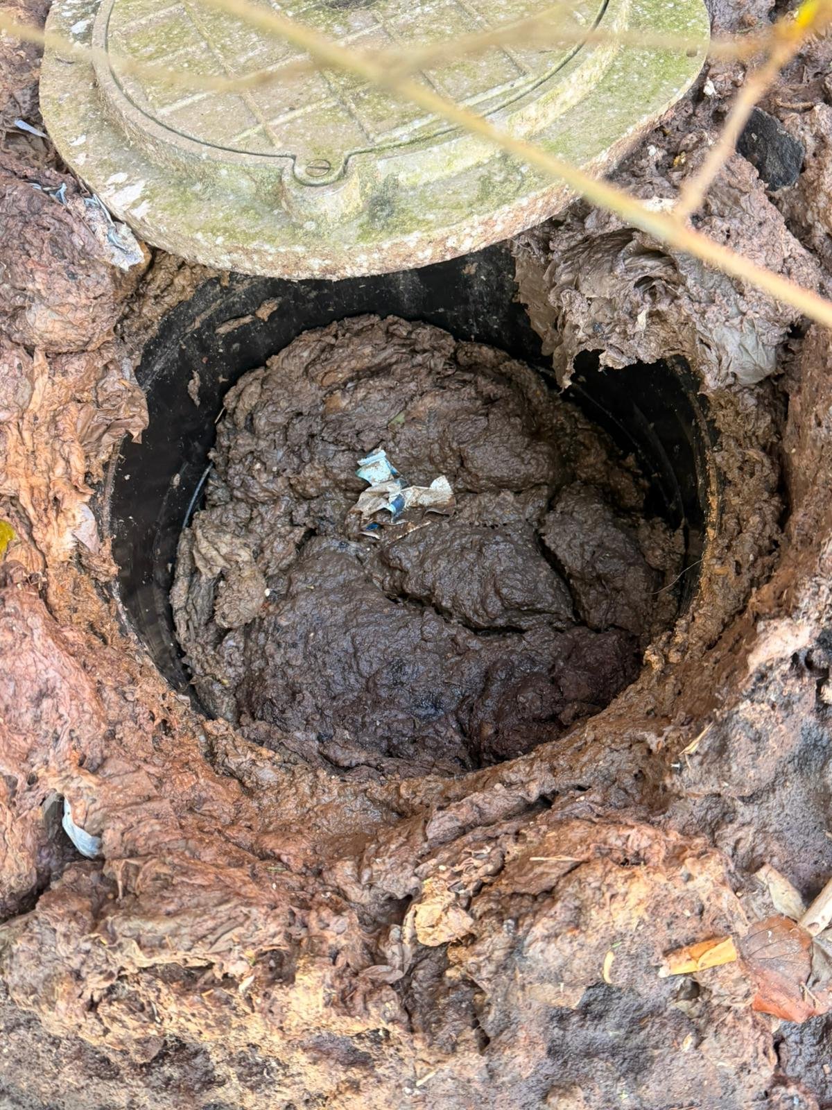 Professional drain unblocking service fixing a stubborn blocked drain using high-pressure equipment