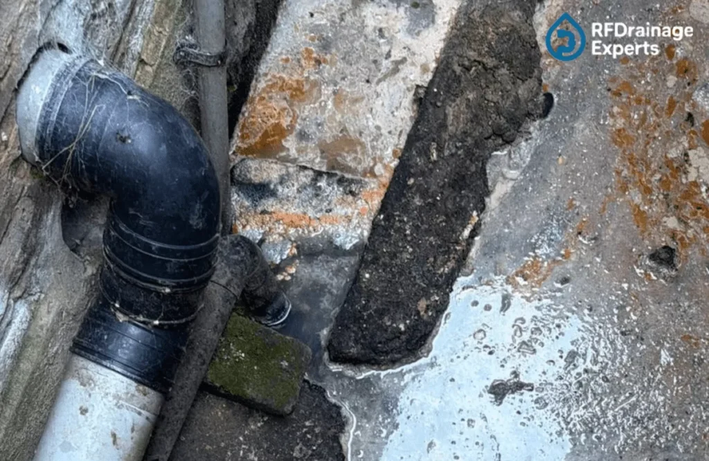 Professional team working to Unblock External Drains in London residential area using high-pressure jetting equipment.