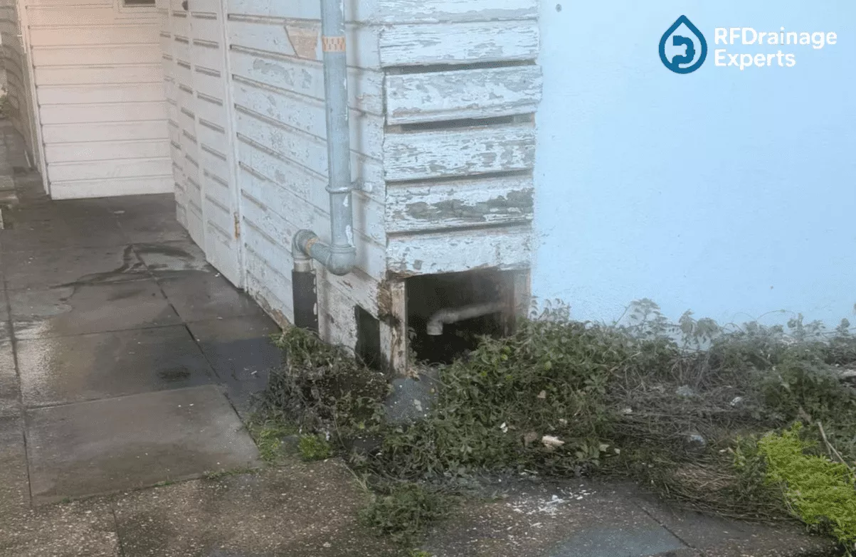 Engineer inspecting blocked outdoor pipe system before starting to Unblock External Drains in London.